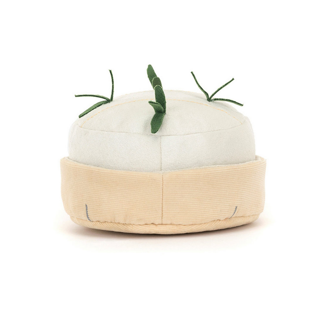 White plush toy with green leaves on a white background