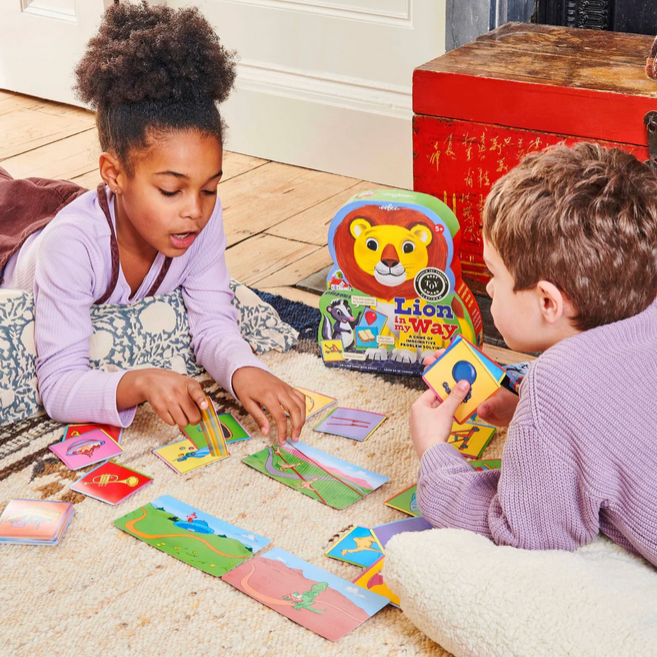Two children playing with a educational toy on the floor.