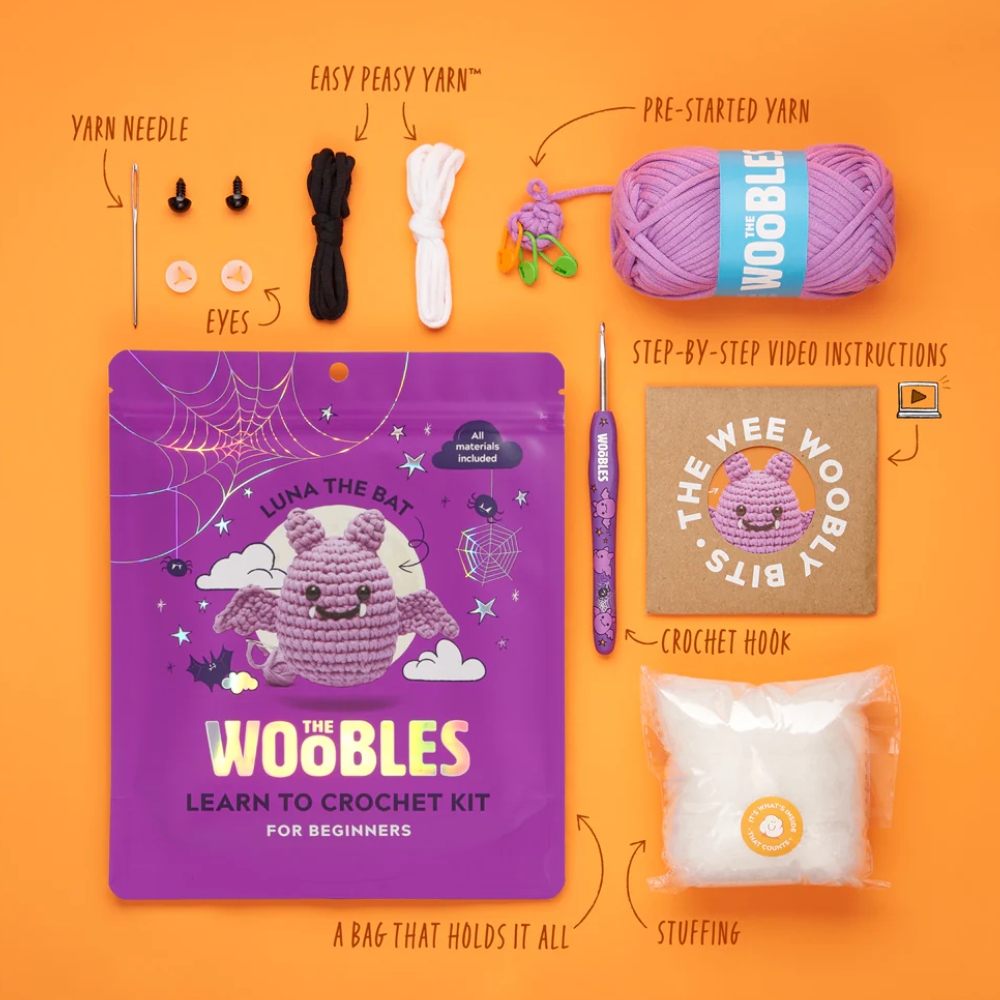 Crochet kit for beginners with all necessary items on an orange background