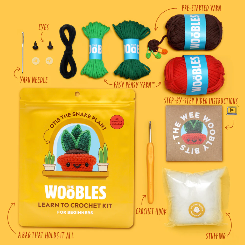 Woobles learn to crochet kit with yarn, hooks, and instructions on a yellow background