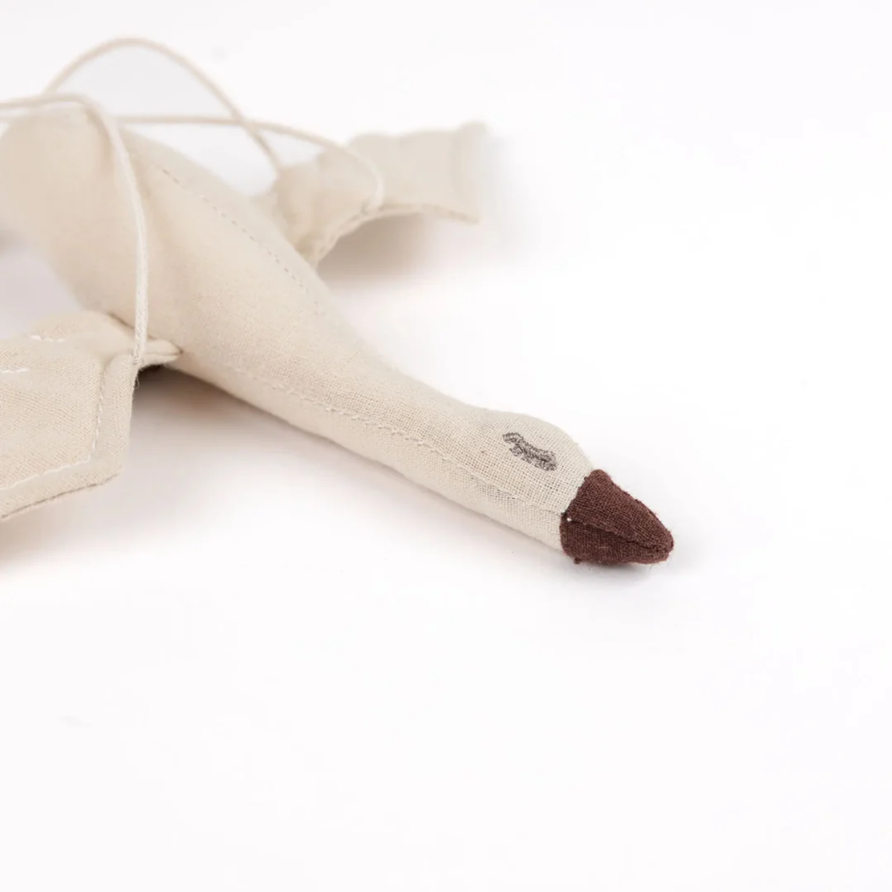 Beige fabric swaddle with brown accents on a white background