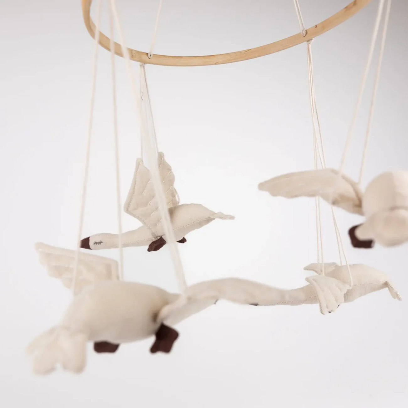 Decorative mobile with flying bird shapes on a white background
