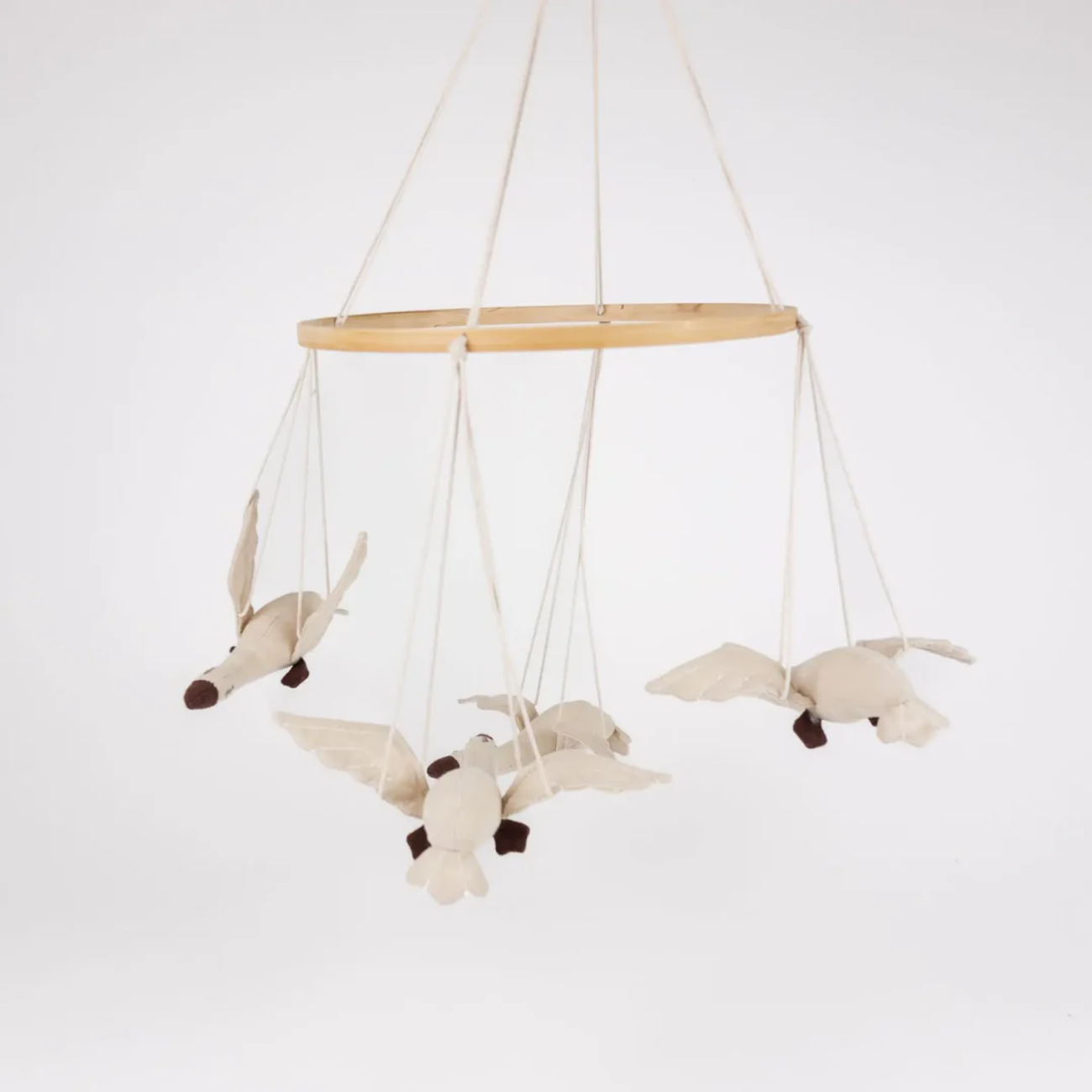 Wooden crib mobile with fabric birds on a white background