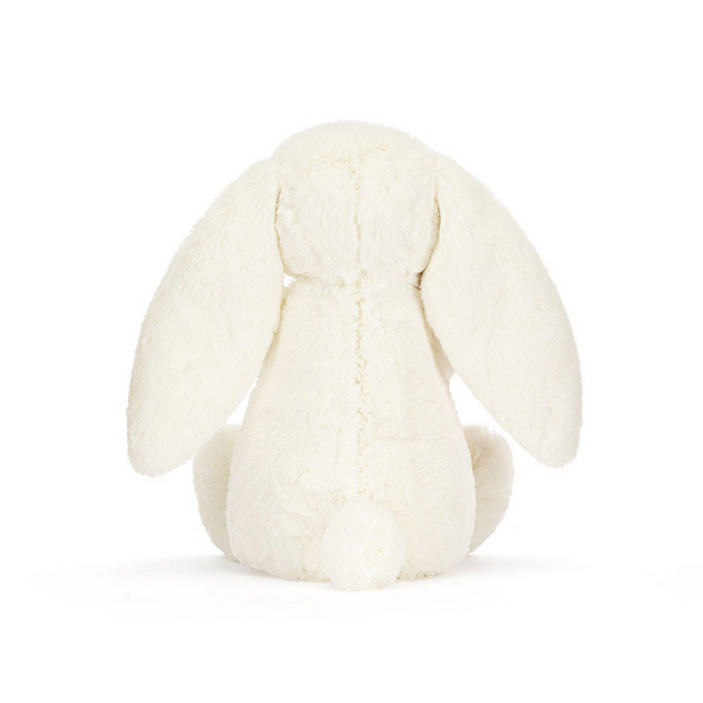 Cream-colored bunny plush toy with a rose on a white background
