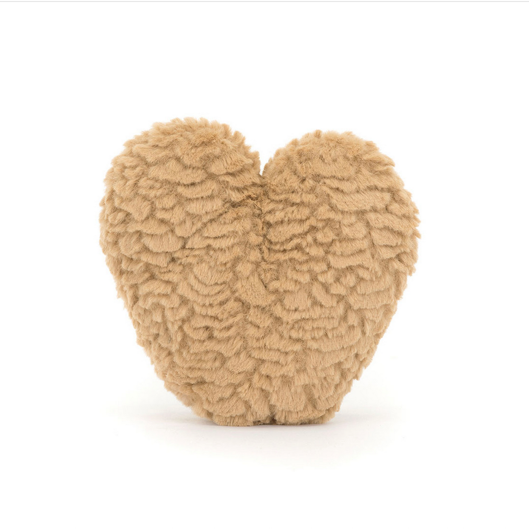 Heart-shaped beige plush toy on a white background