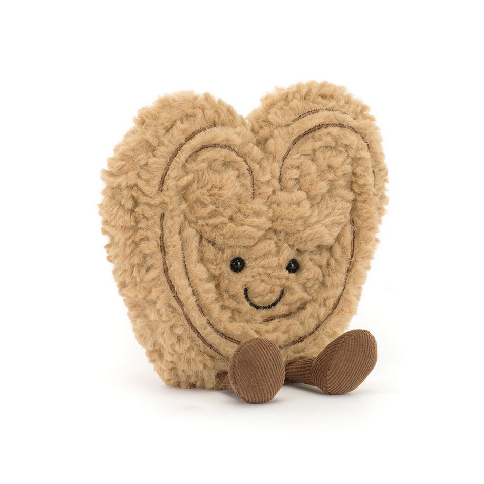 Heart-shaped plush toy with a face on a white background