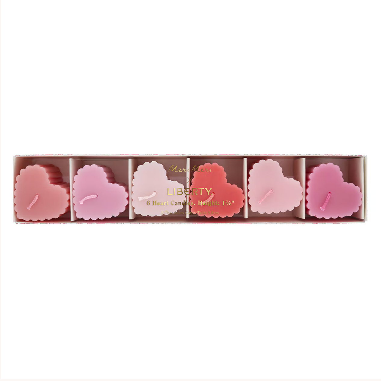 Set of heart-shaped candles in a box on a white background