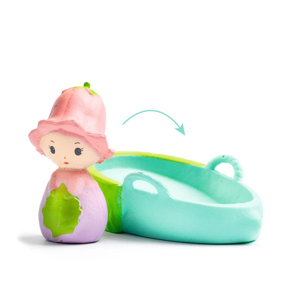 Toy figure of a girl with a pink hat and green outfit on a white background