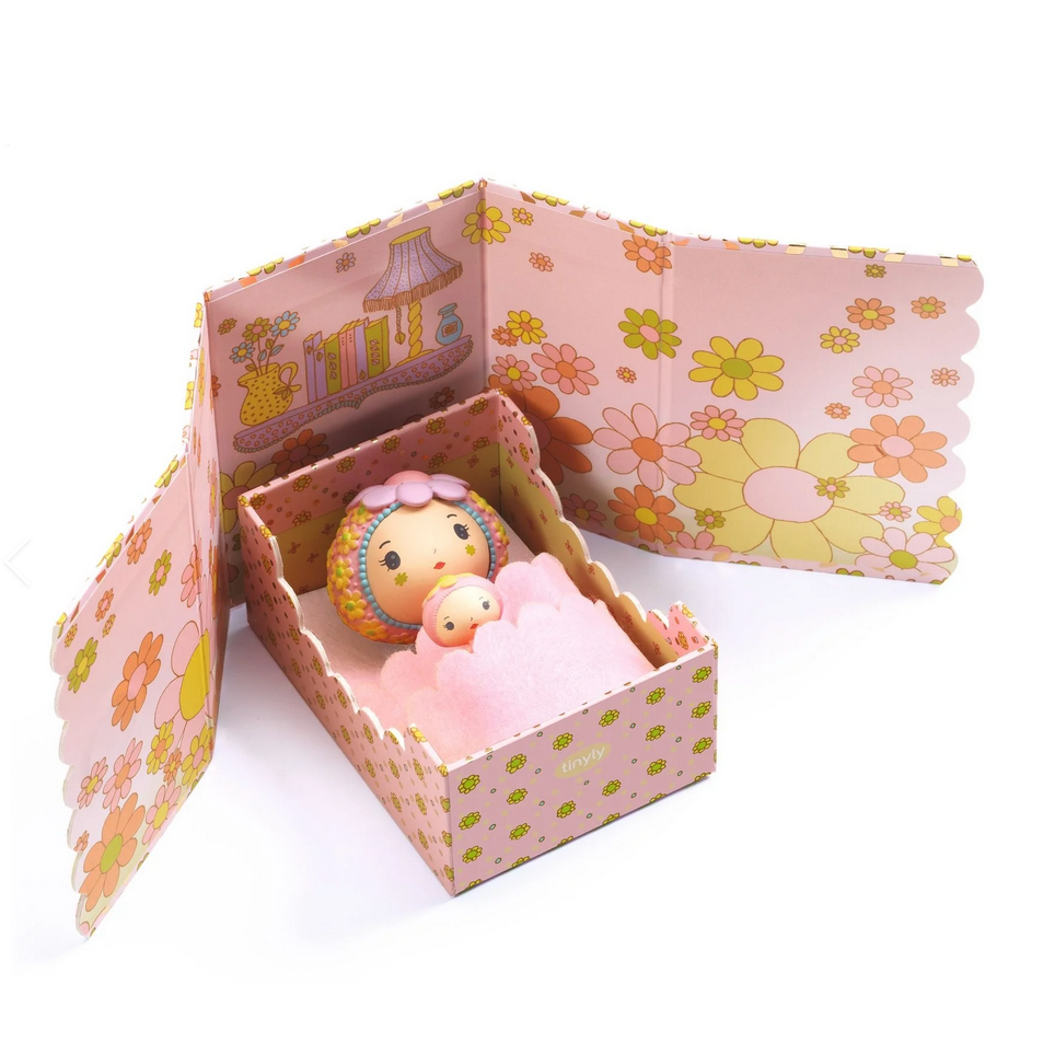 Floral-patterned toy box with a small toy inside on a white background, featuring the Djeco brand.