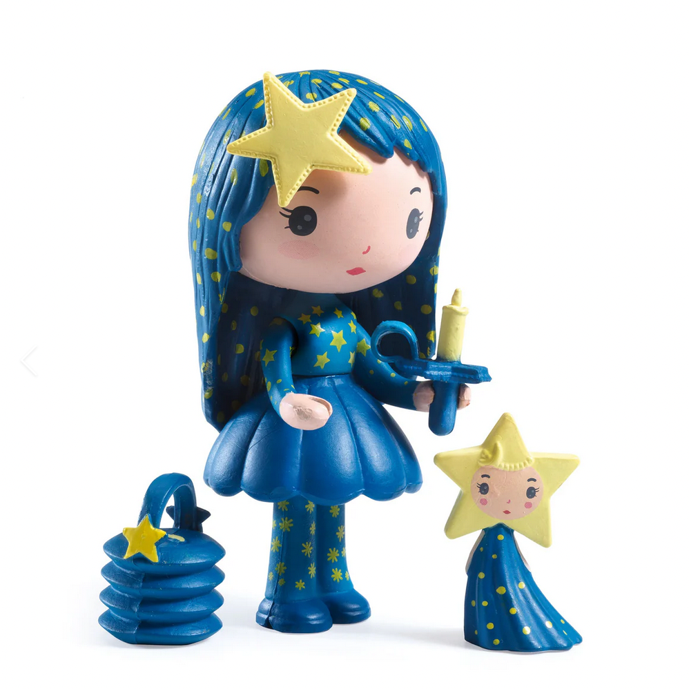 Toy figure with blue hair and dress, holding a star and candle, on a white background.