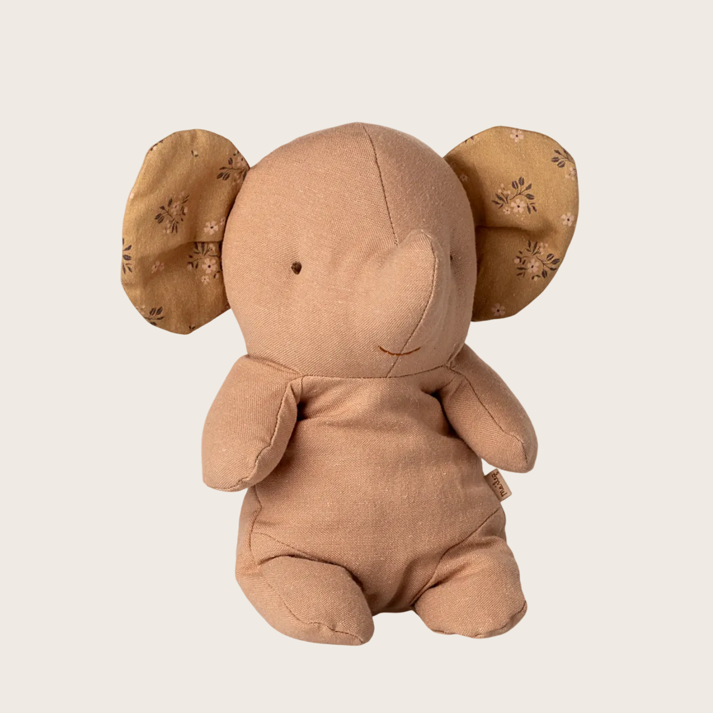 Brown plush elephant toy on a white background