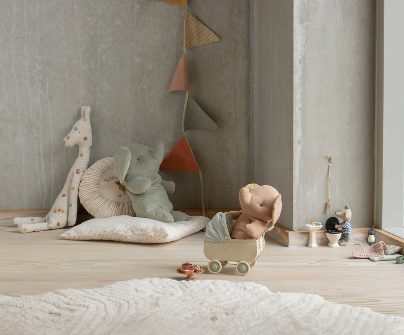 Children's room with toys and a lamp on a wooden floor.