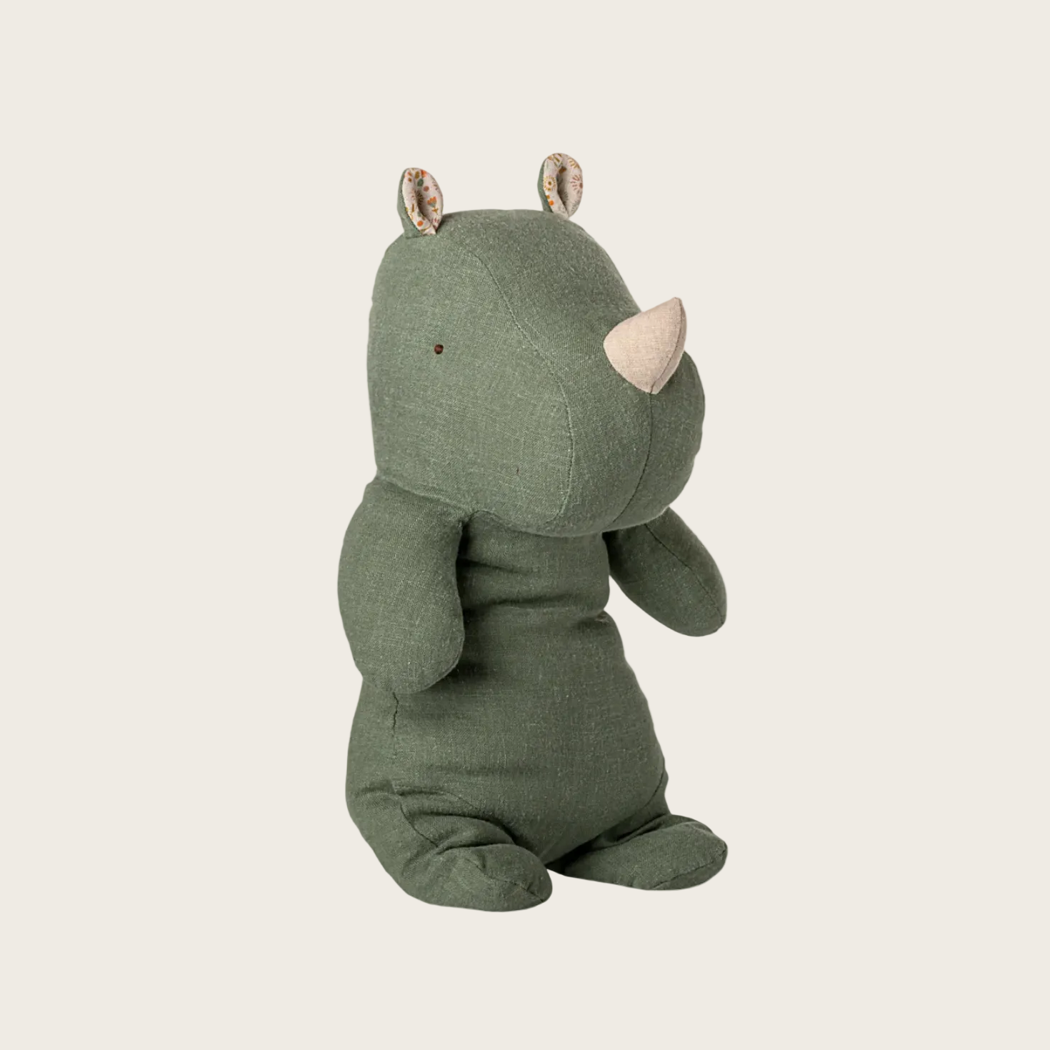 Green rhinoceros plush toy on a white background