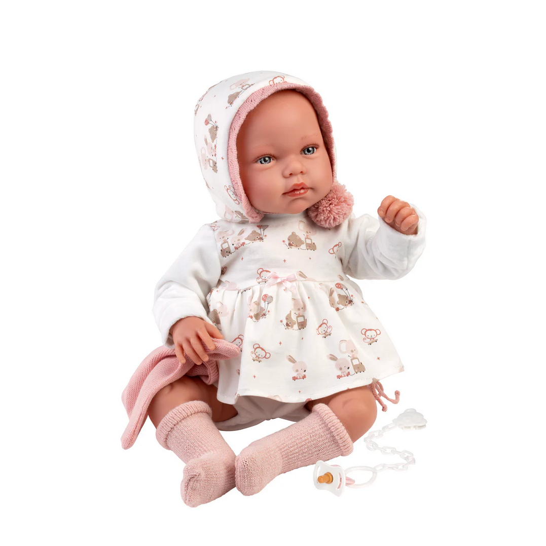 Baby doll in a floral outfit with a white background