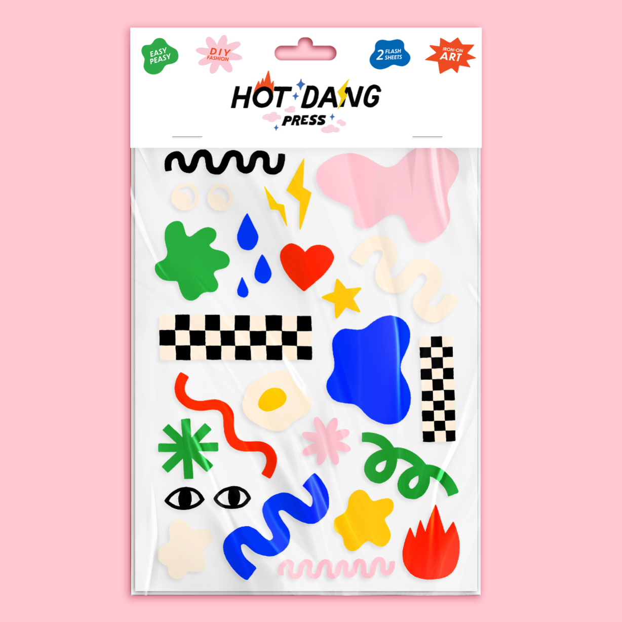 Packaging of Hot Dang Press iron-on's with colorful designs on a pink background