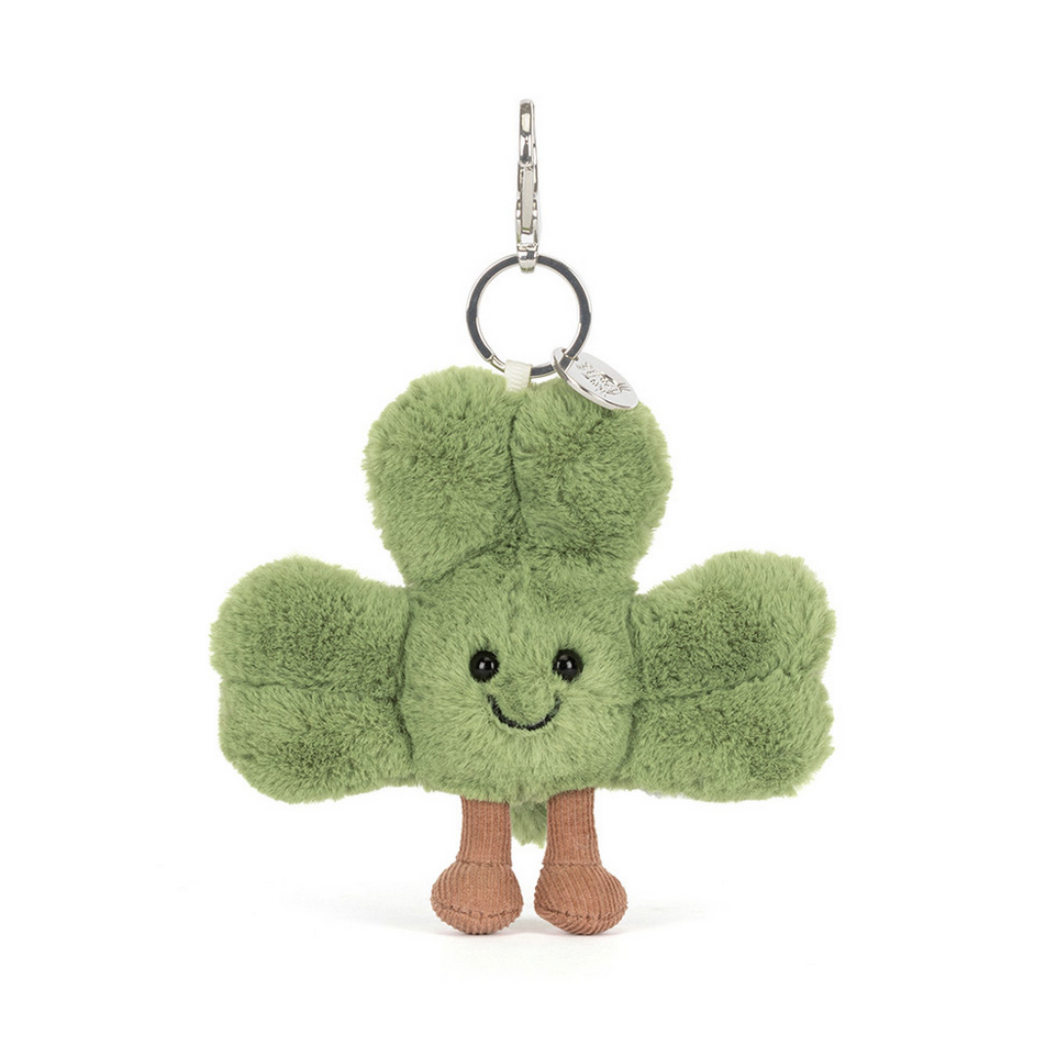 Green plush keychain with a smiling face on a white background