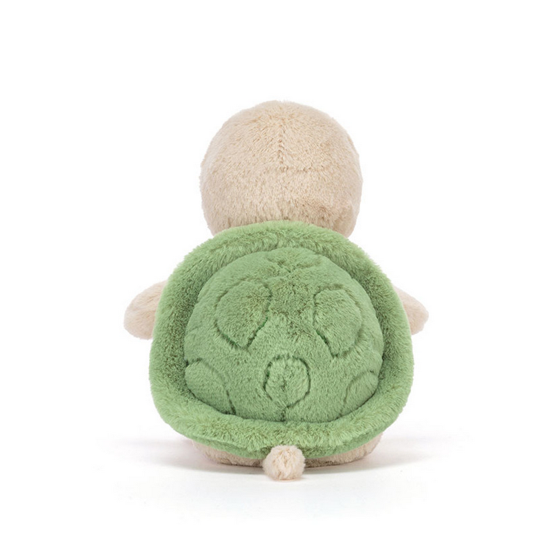 Plush turtle toy with green shell on a white background