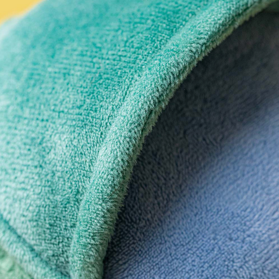 Close-up of a textured green and blue fabric surface