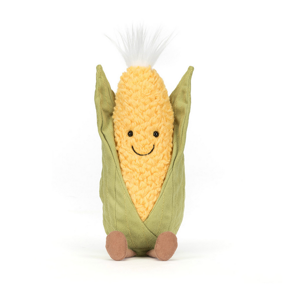 Toy sweetcorn with a smiling face on a white background