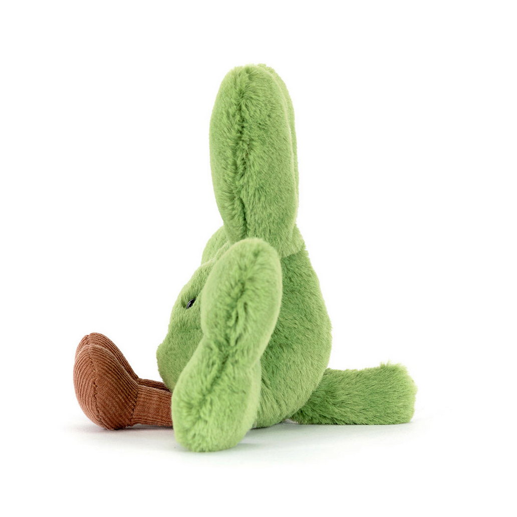 Green plush toy with brown feet on a white background