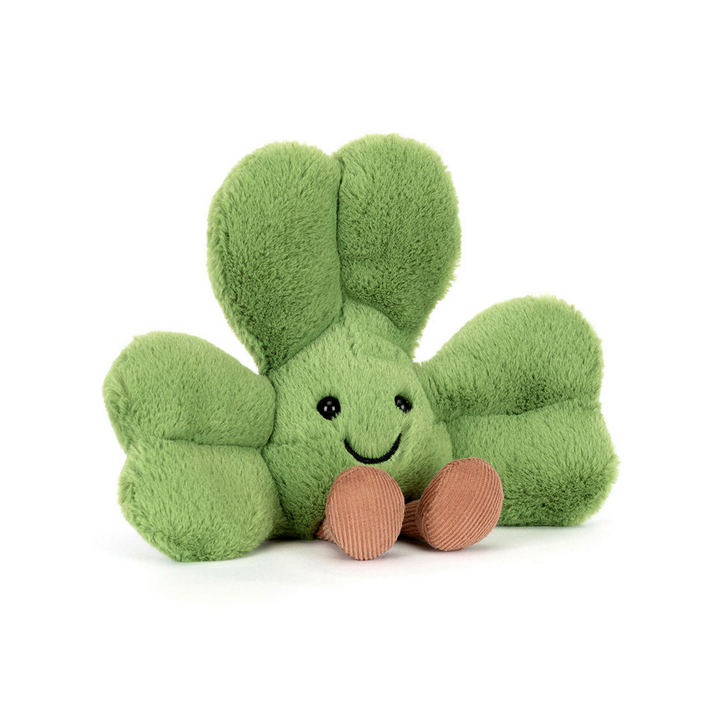 Green plush shamrock toy with a smiling face on a white background