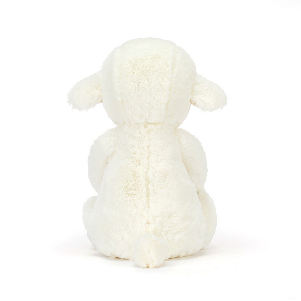 White knitted sheep toy on a white background