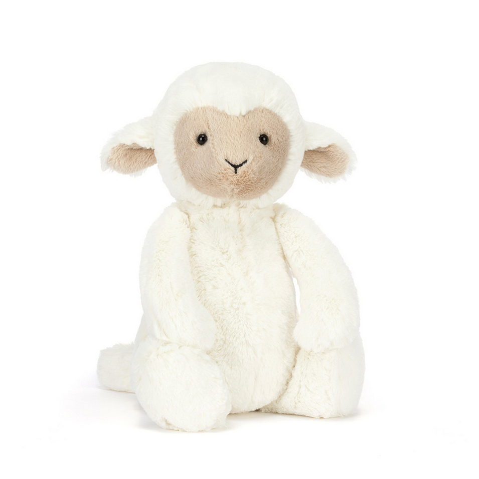 White stuffed lamb toy on a white background