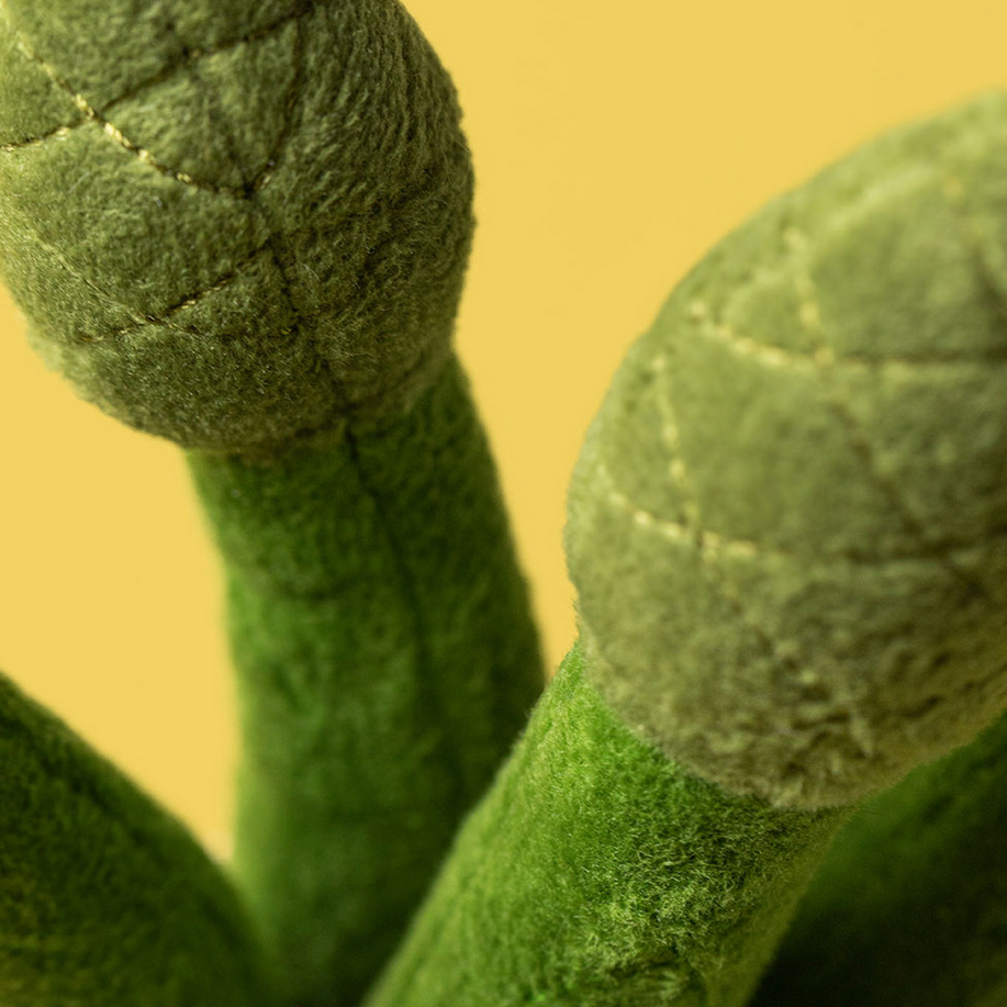 Close-up of green textured fabric with a yellow background