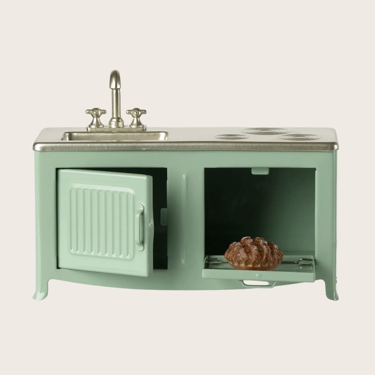 Green kitchen playset with sink and oven on a website page