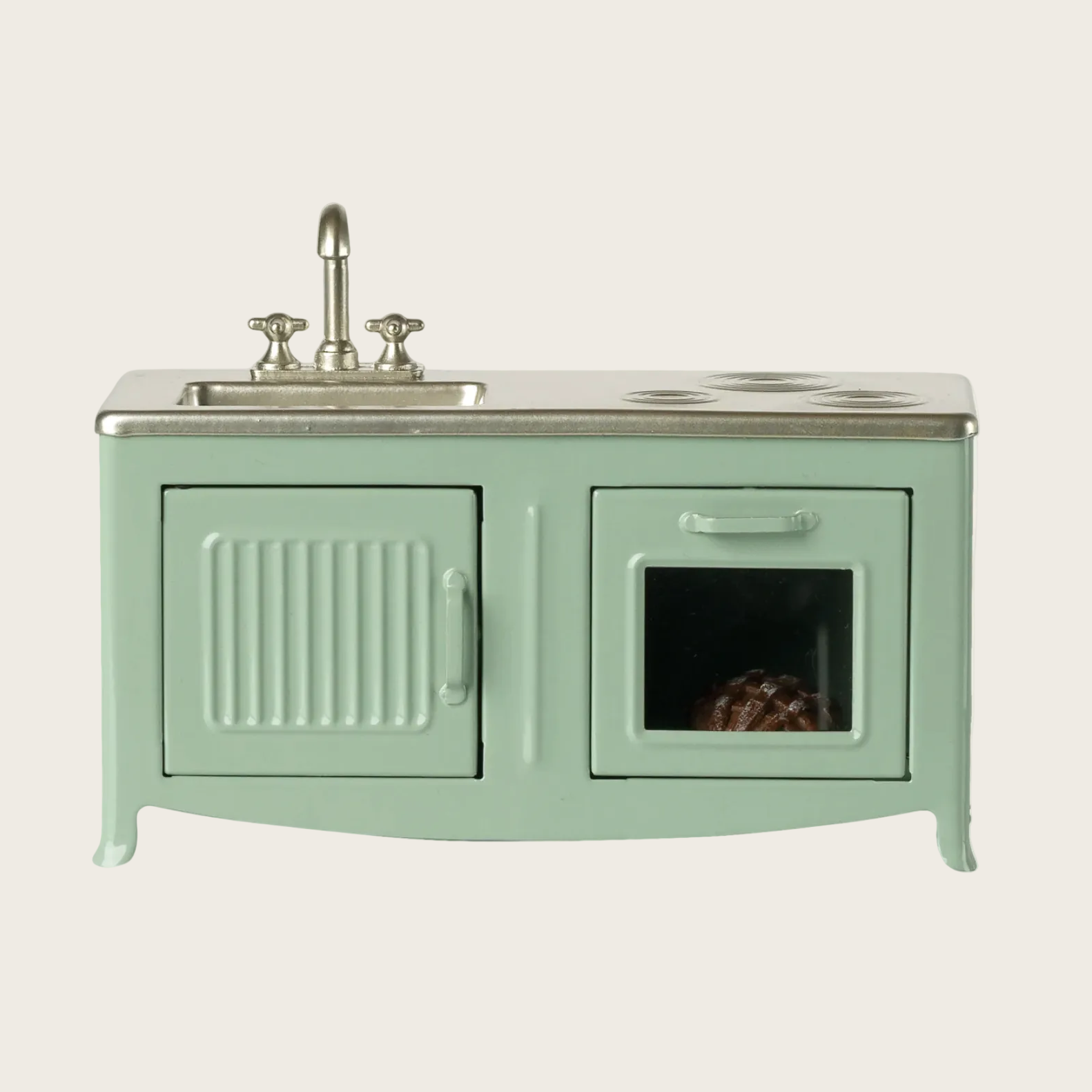 Mint green vanity with sink and mirror on a light beige background