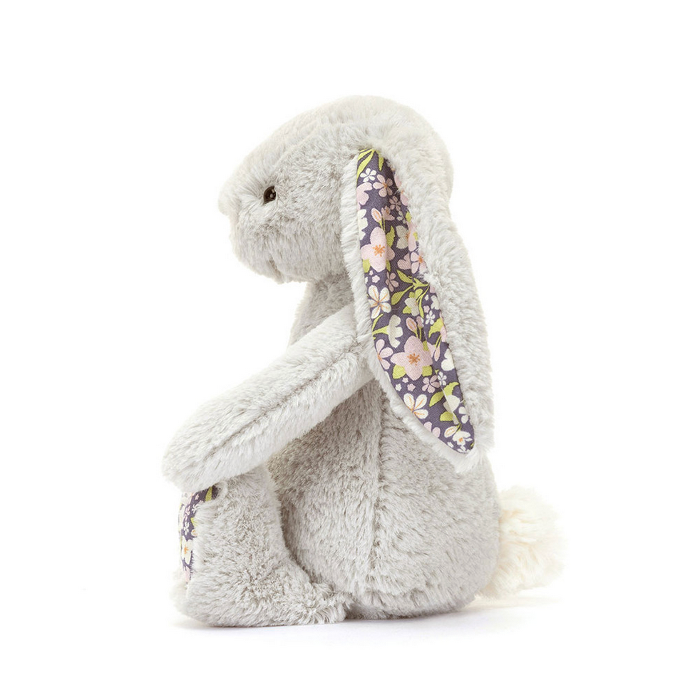 Plush toy rabbit with floral ears on a white background