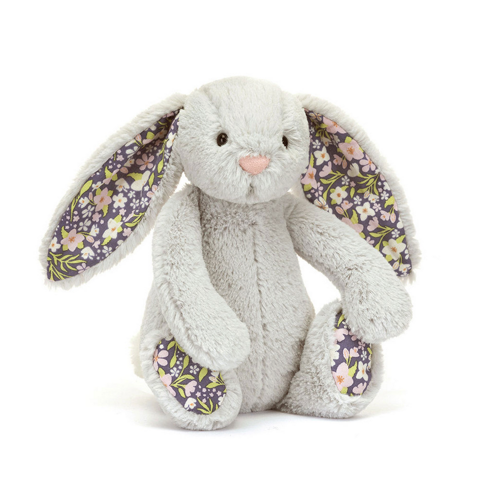 Floral-patterned plush bunny toy on a white background
