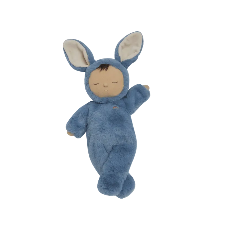 Stuffed toy in a blue bunny costume on a beige background