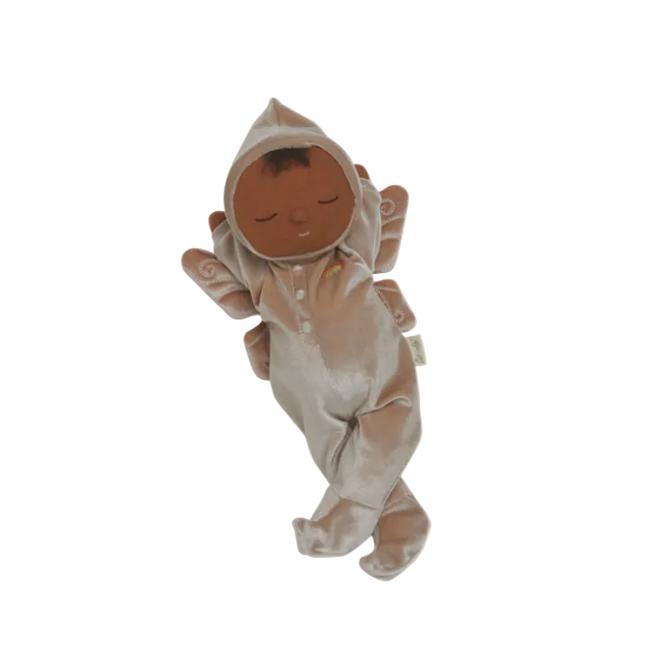 Baby doll in a onesie with a hood on a beige background