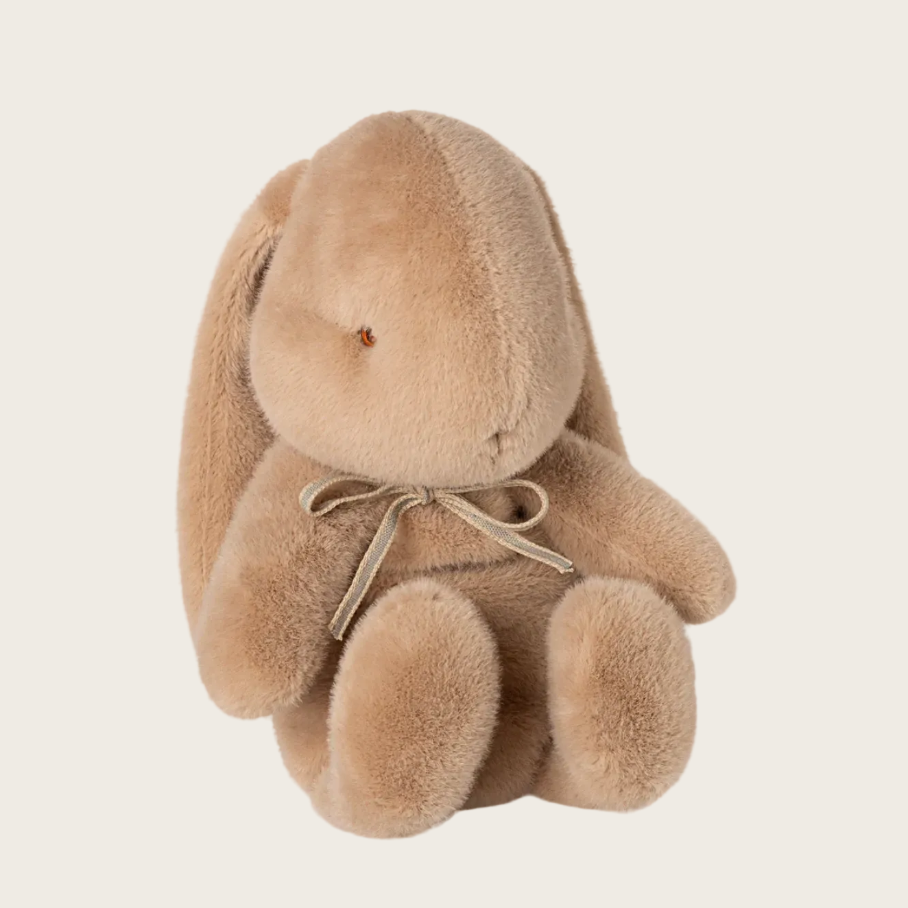 Beige plush bunny toy on a white background