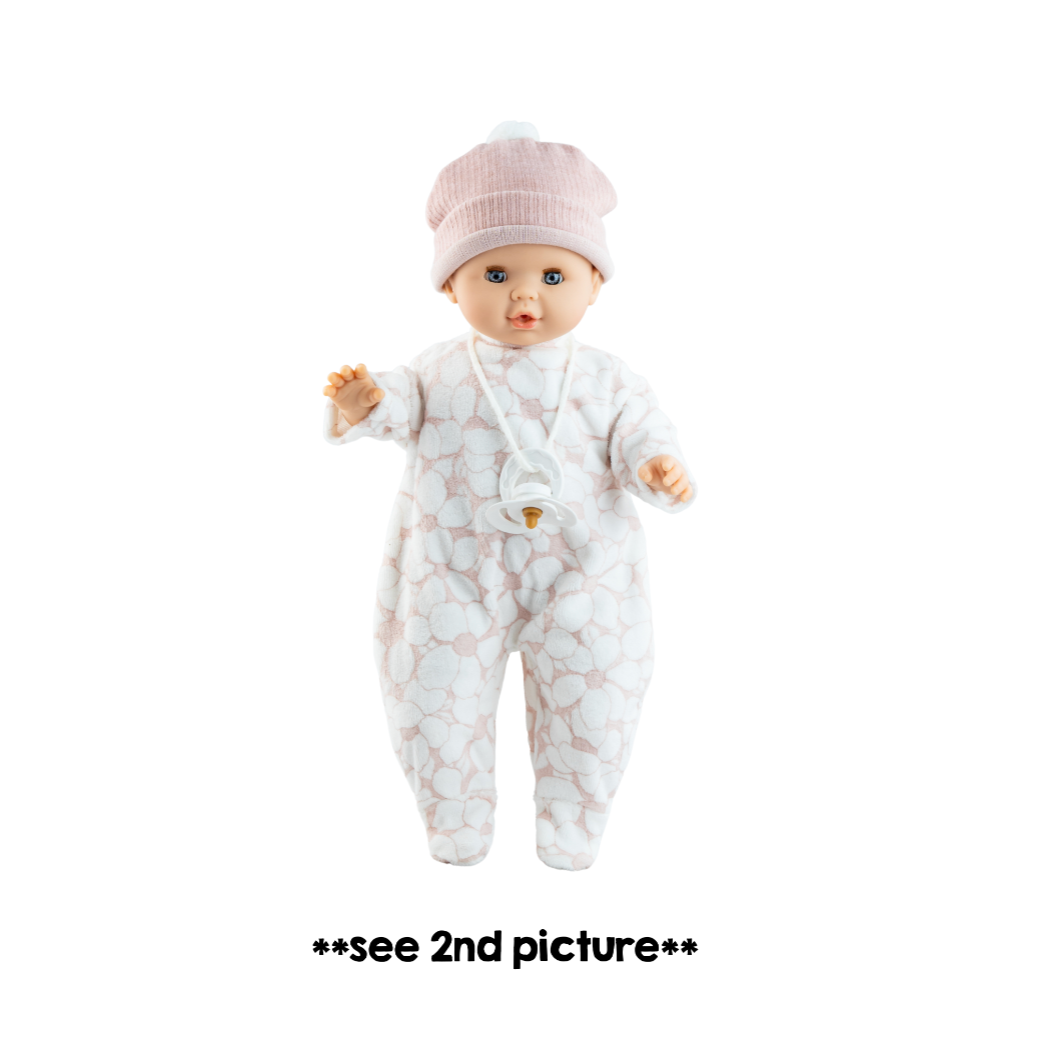 Baby doll in a white outfit with star pattern on a black background