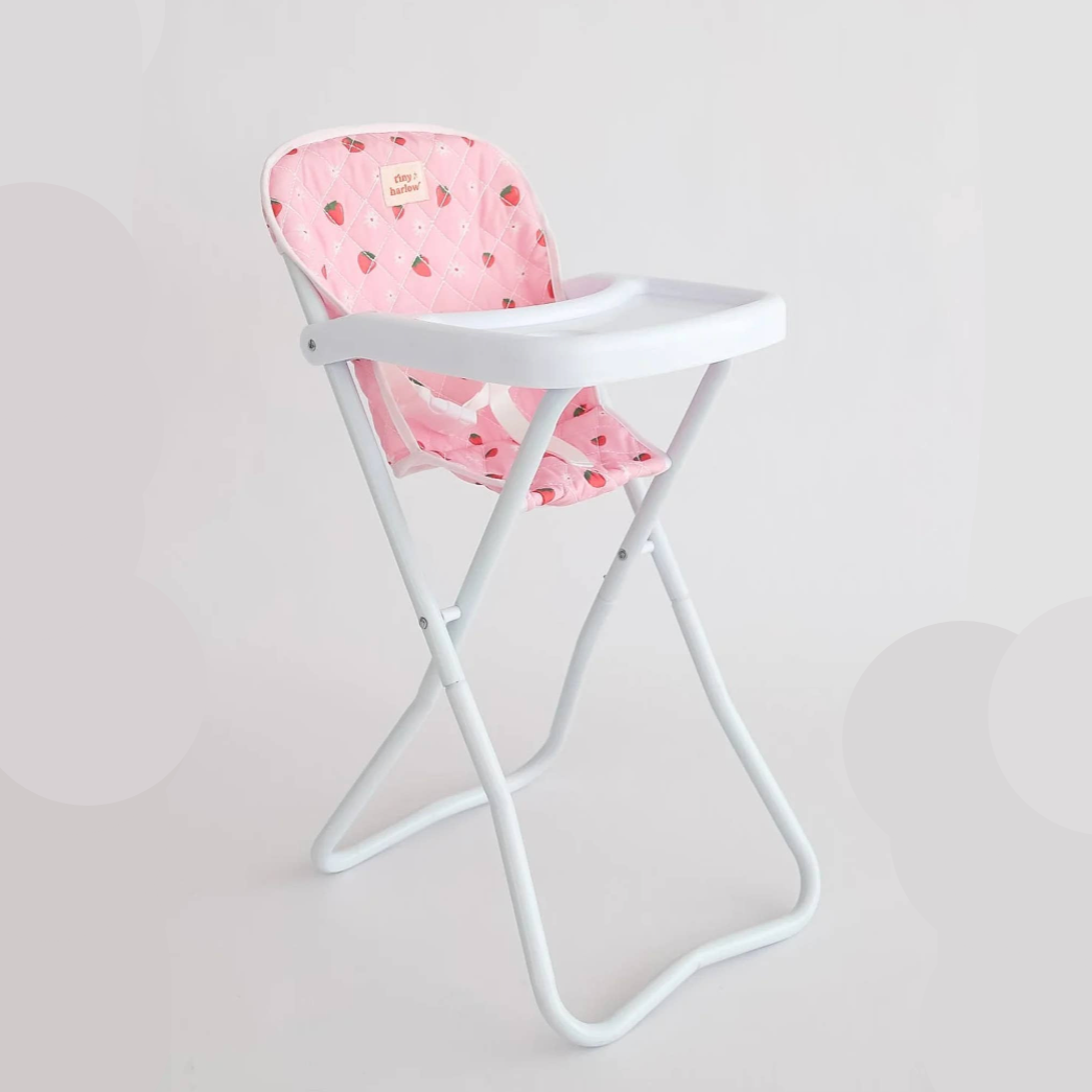 White high chair with pink cushion on a light gray background