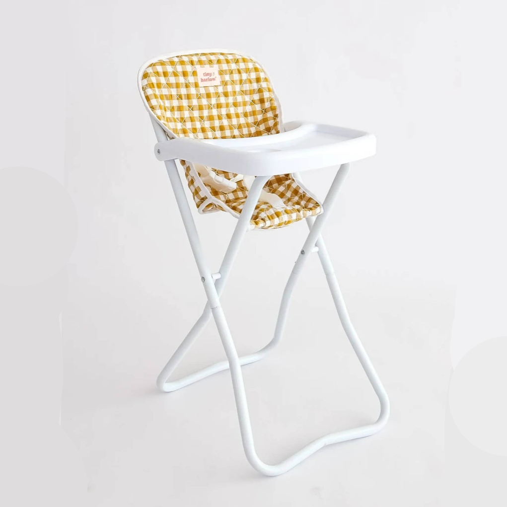 White chair with a yellow checkered cushion on a light gray background