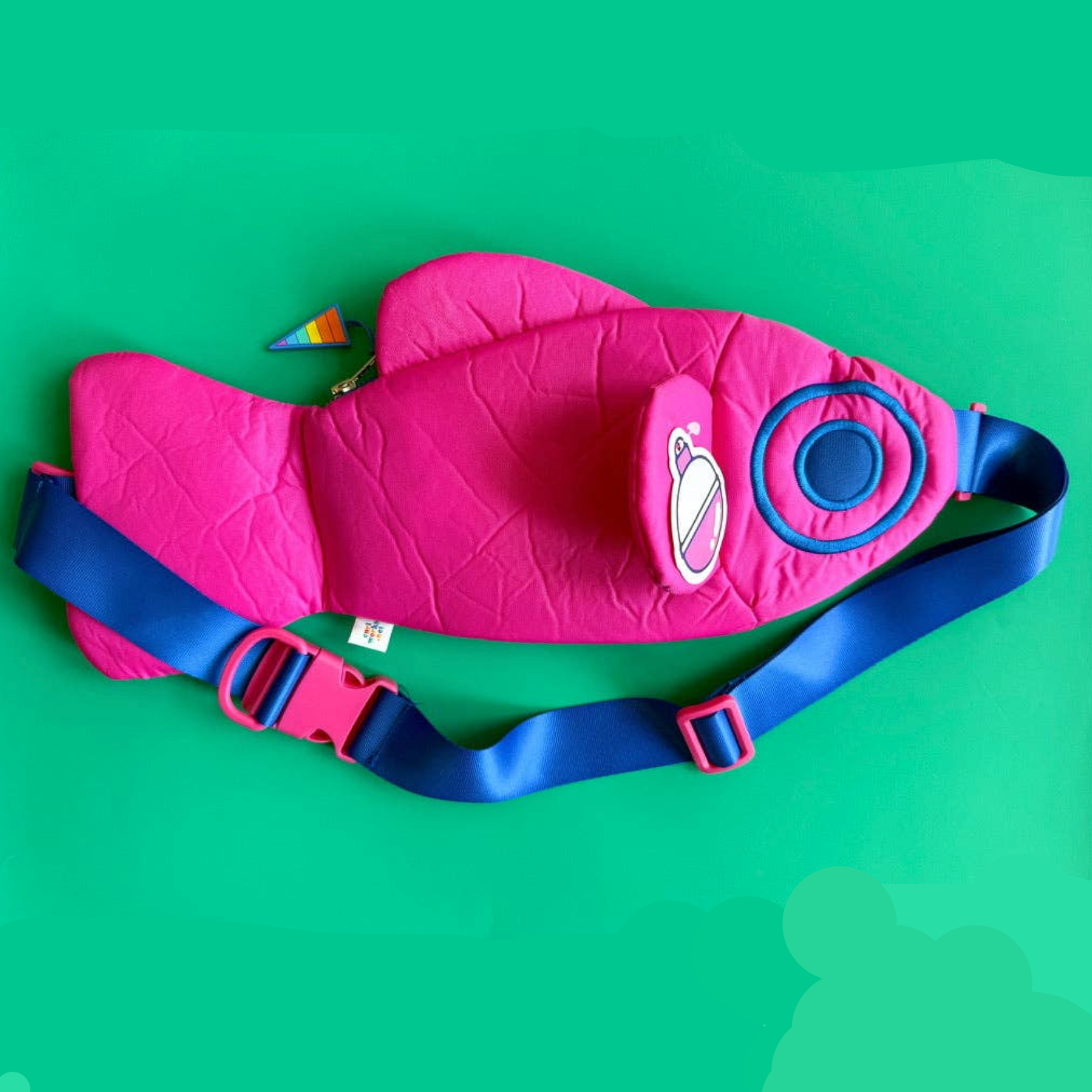 Pink and blue fanny pack on a green background