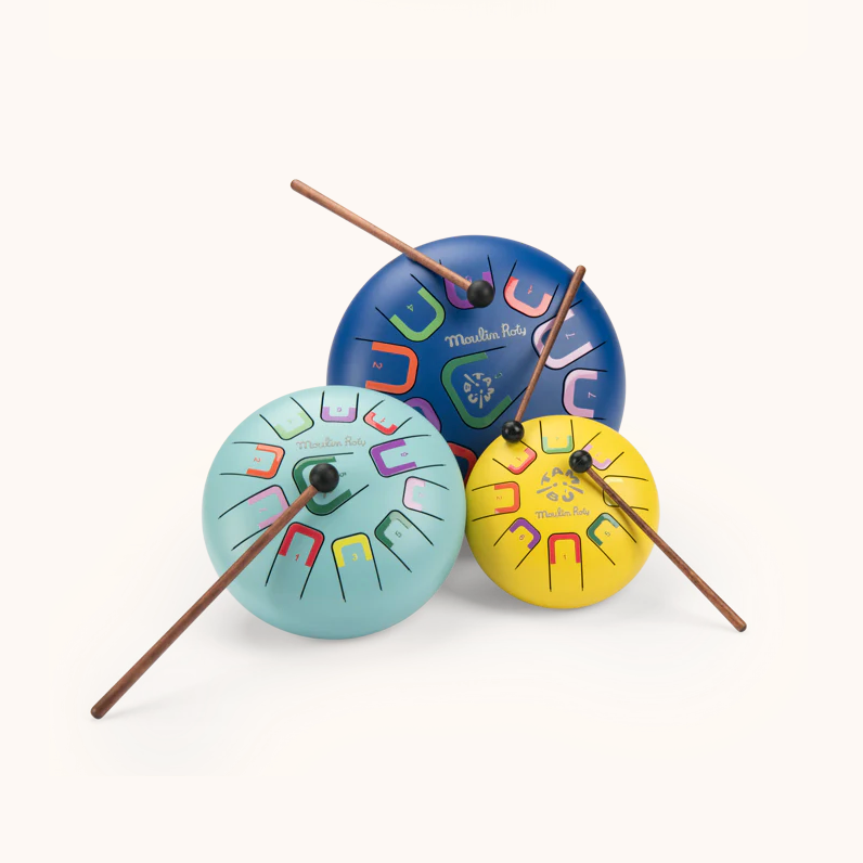 Colorful wooden drums with drumsticks on a white background