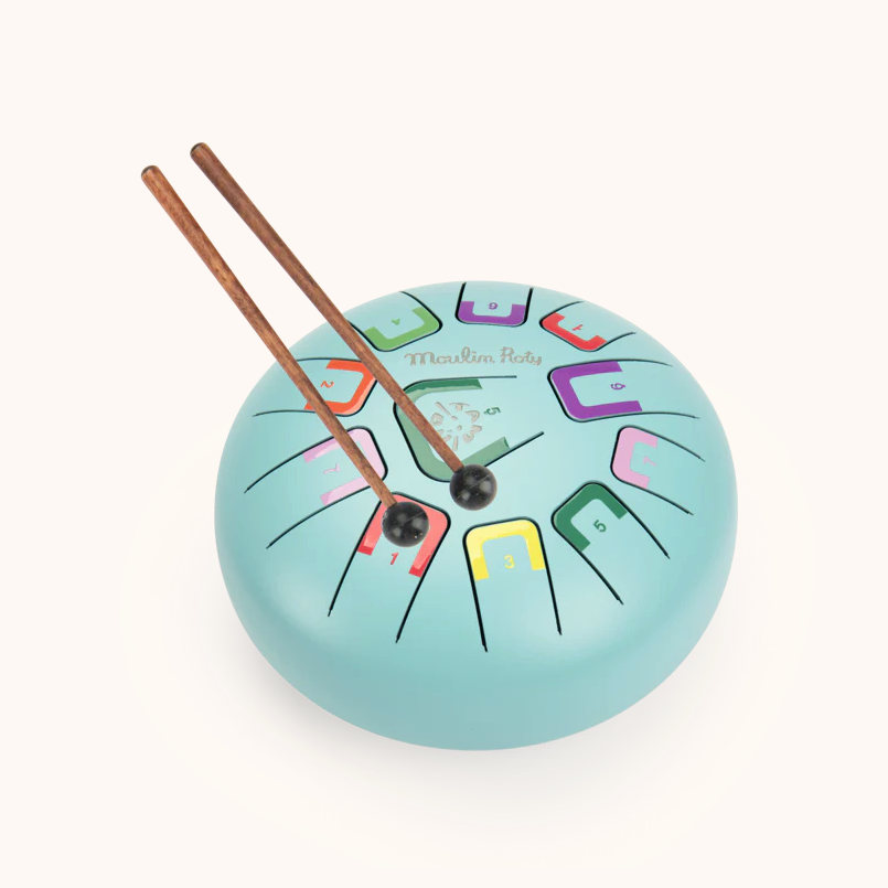 Colorful drum-shaped clock with drumsticks on a white background