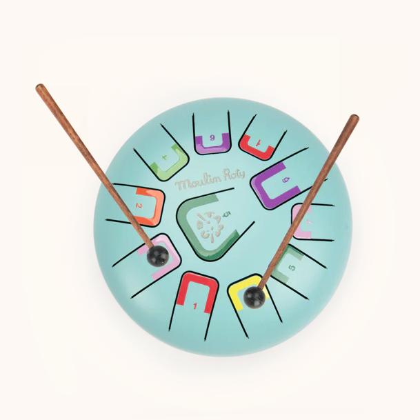 Colorful drum with wooden hands on a white background