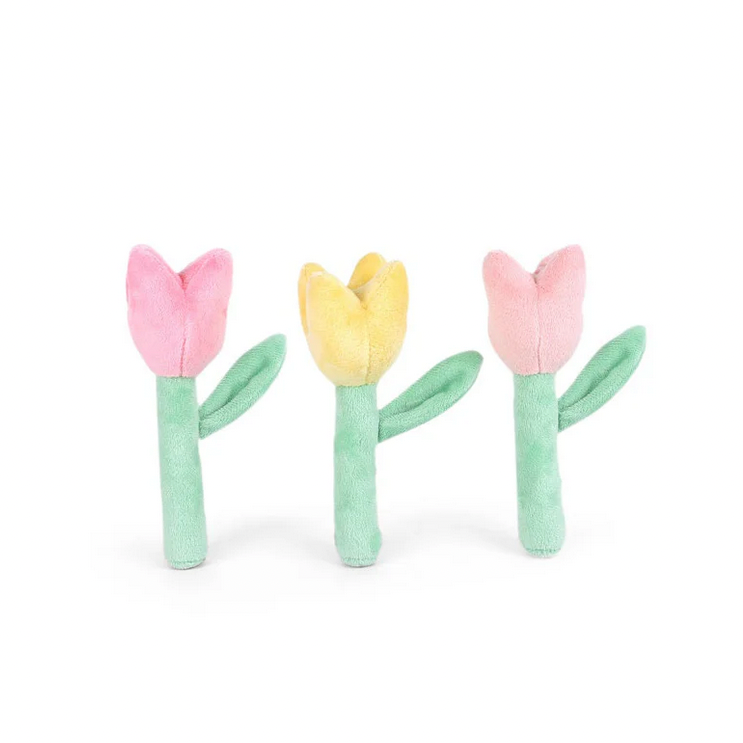 Three pastel-colored tulip-shaped toys on a white background