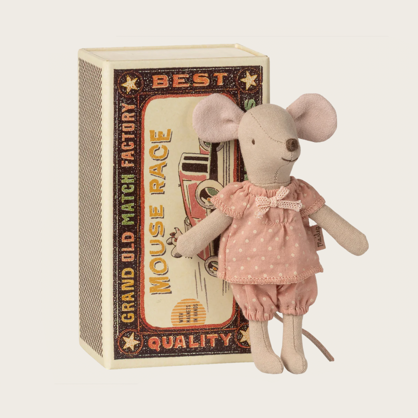 Stuffed mouse toy in a pink outfit standing next to a vintage-style matchbox
