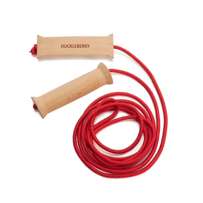 Red jump rope with wooden handles on a white background