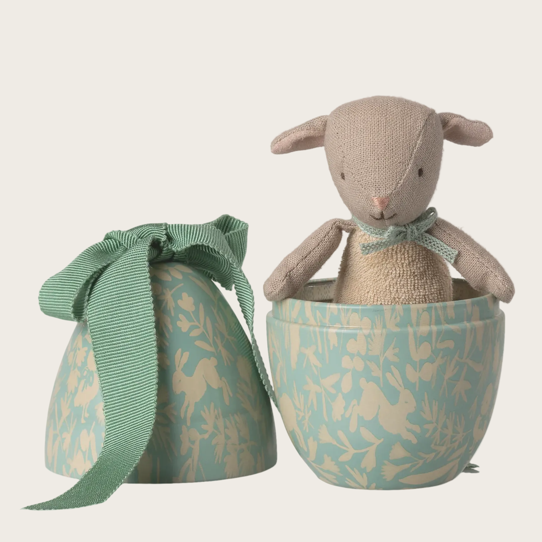 Stuffed lamb toy with a decorative egg