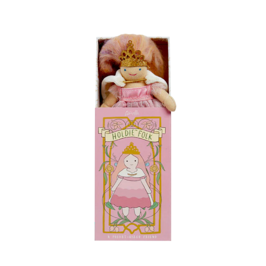 Doll in a pink box with 'Holdie Folk' branding on a white background