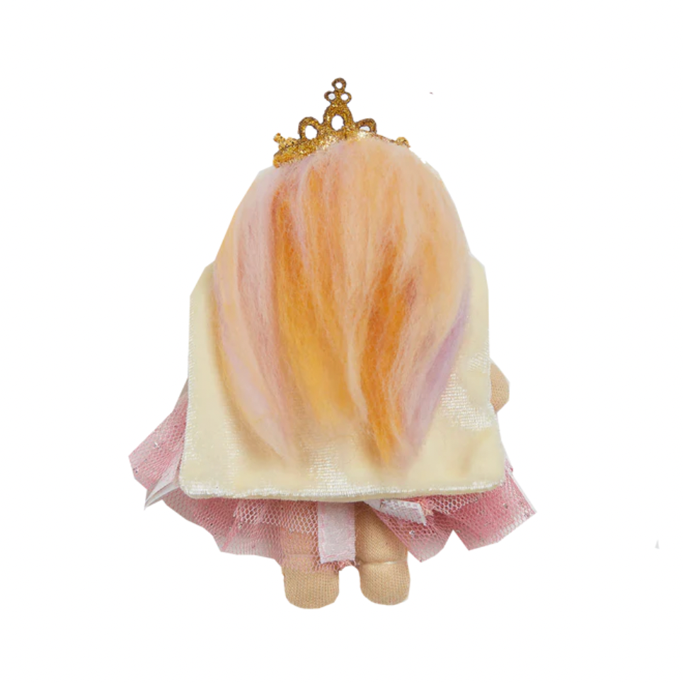 Small figurine with a gold crown, white dress, and pink skirt on a white background