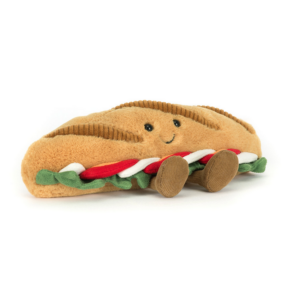 Toy shaped like a baguette with smiling face on a white background