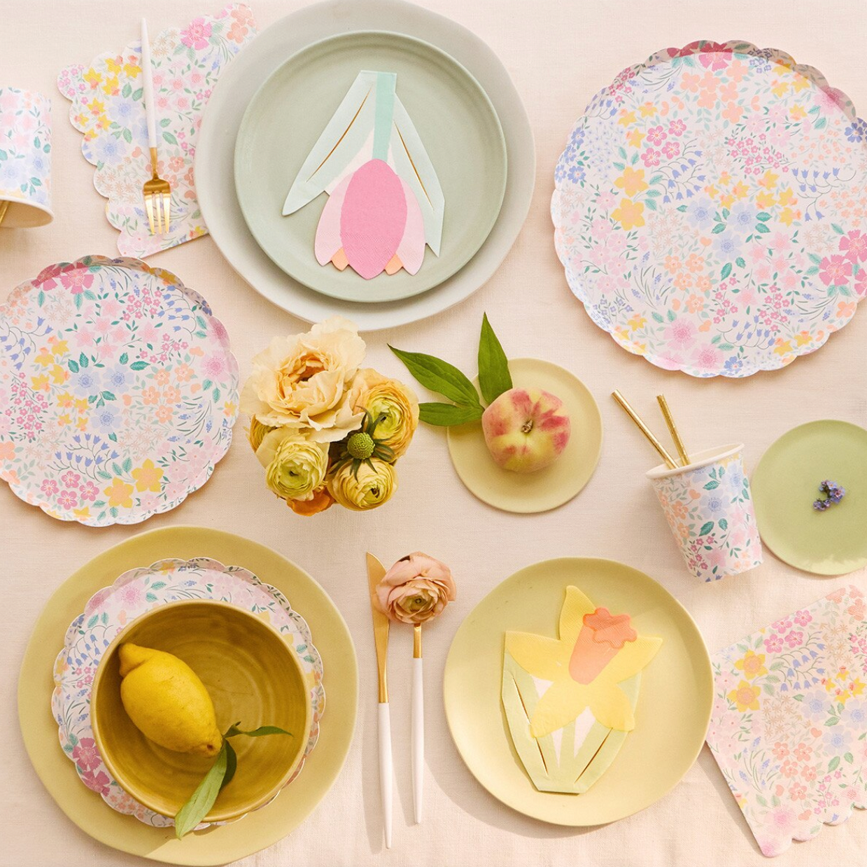 Pastel-colored tableware set with floral patterns on a light background